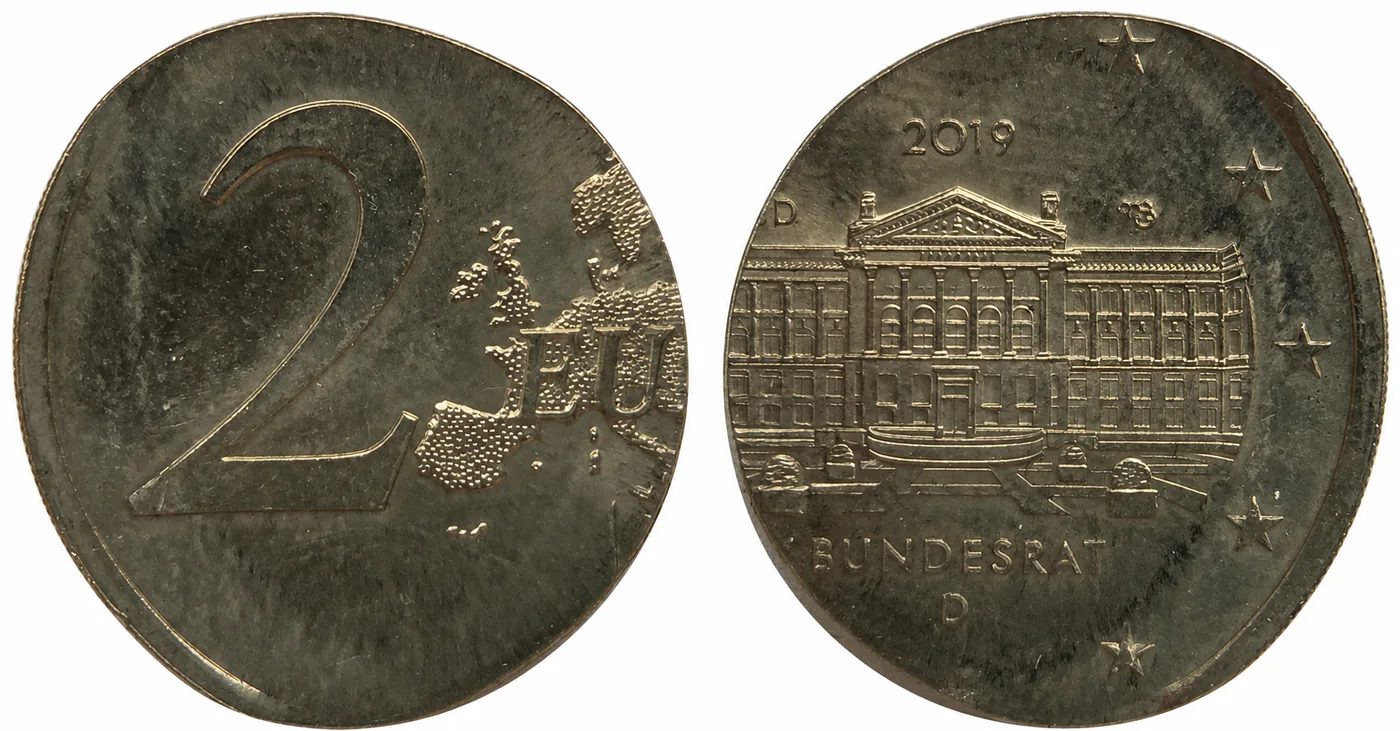 Zum Vergrößern klicken Deutschland 2 Euro 2019 „Bundesrat“ D, geprägt auf einer einzelnen Pille (ohne Außenring). Ohne die Begrenzung des Rings konnte das Material unregelmäßig nach außen fließen, wodurch das Stück unförmig und im Durchmesser größer ist.